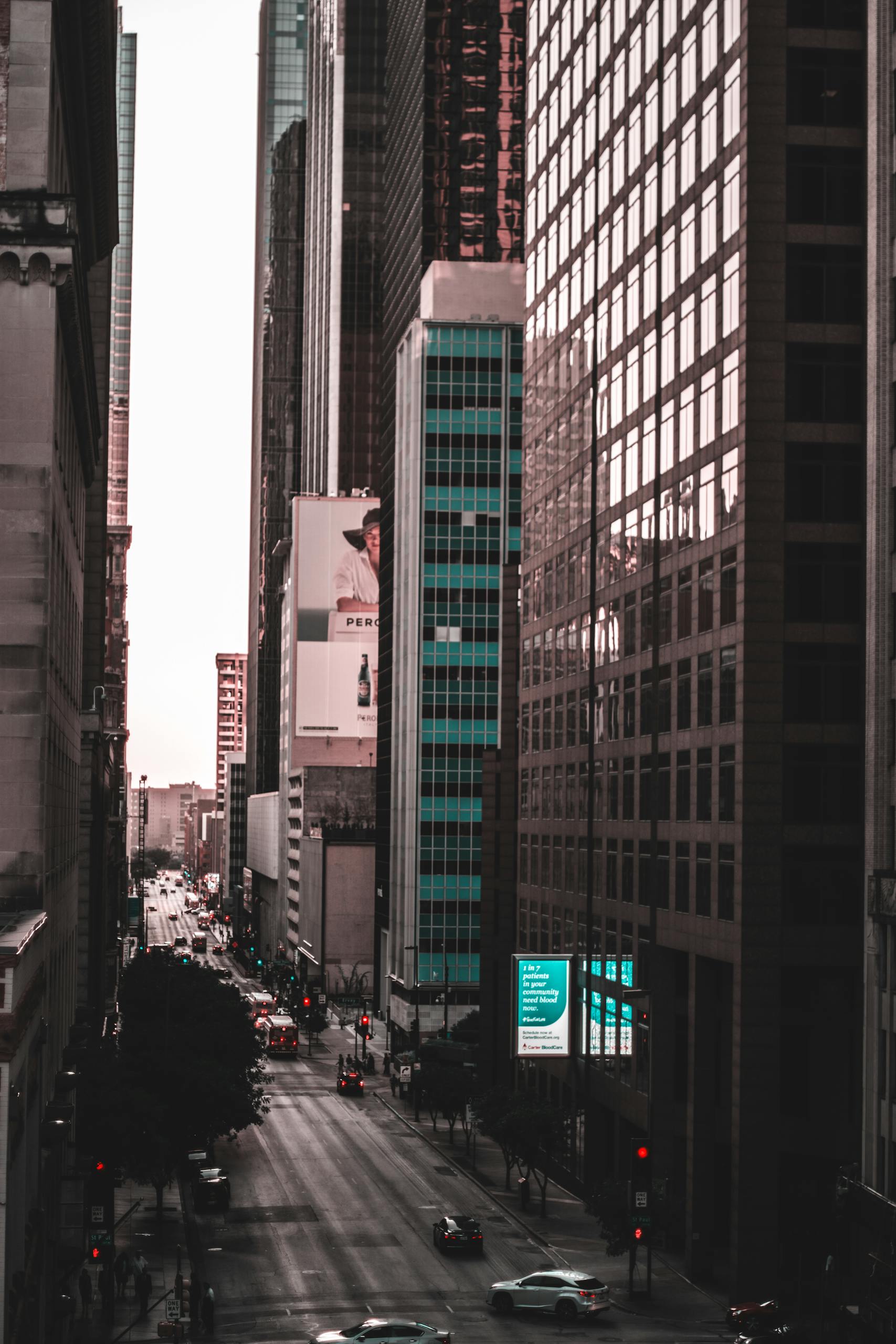 Stunning downtown Dallas cityscape with skyscrapers and busy streets at sunset.